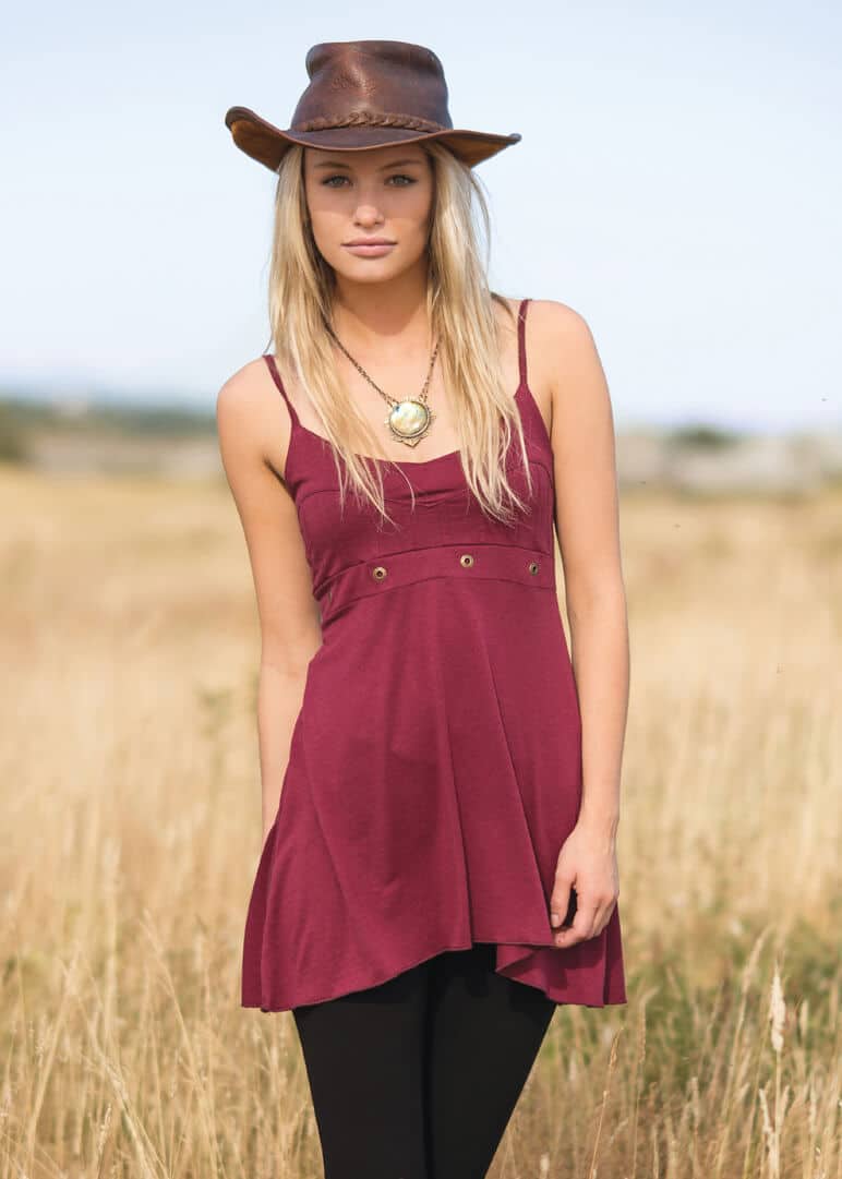 NIrvana Babydoll bamboo dress by nomads hempwear in red on a blonde model with a cowboy hat